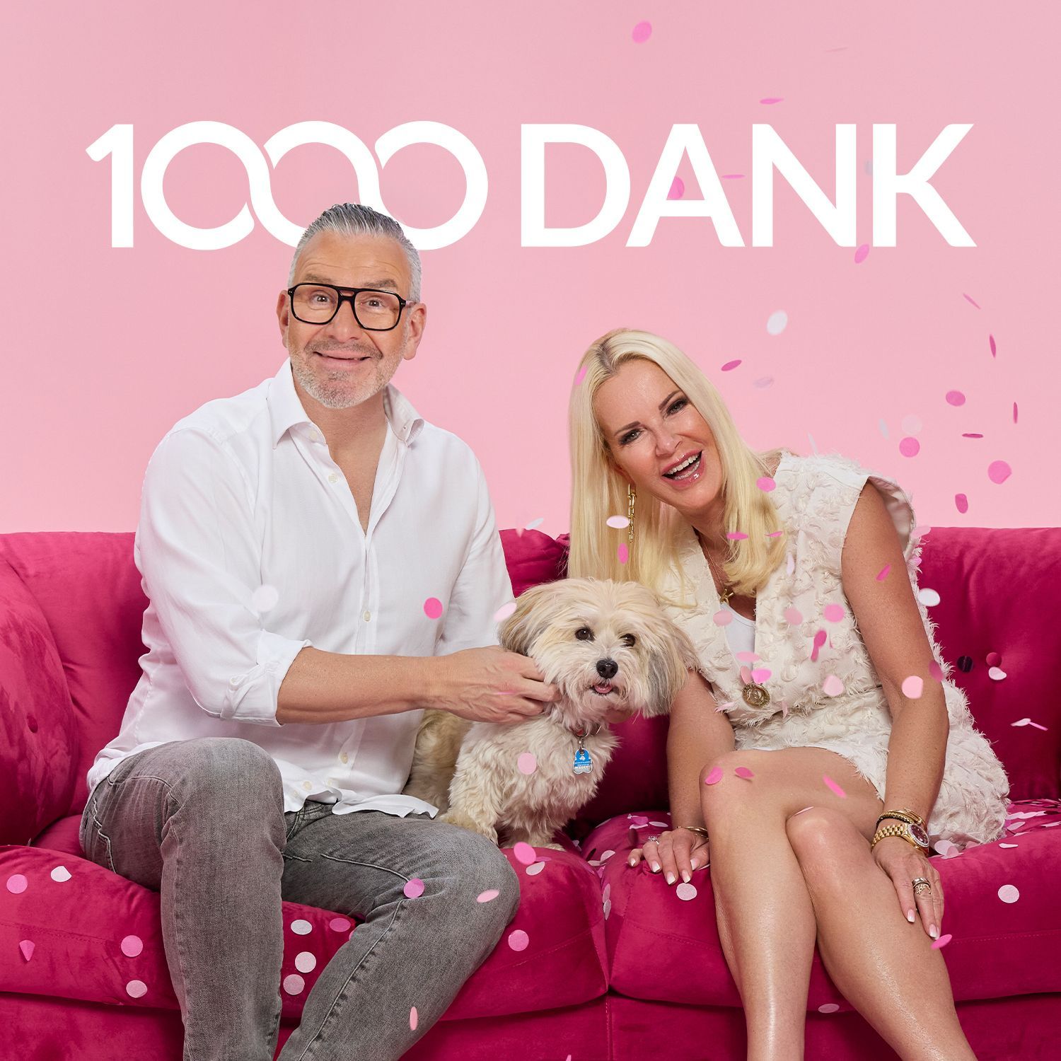 1000 Dank für Ihre Treue! Zwei Personen sitzen auf einem roten Sofa, zwischen ihnen sitzt ein kleiner weißer Hund, rosa Konfetti liegt auf dem Sofa und in der Luft, im Hintergrund steht in großen weißen Buchstaben '1000 DANK'.